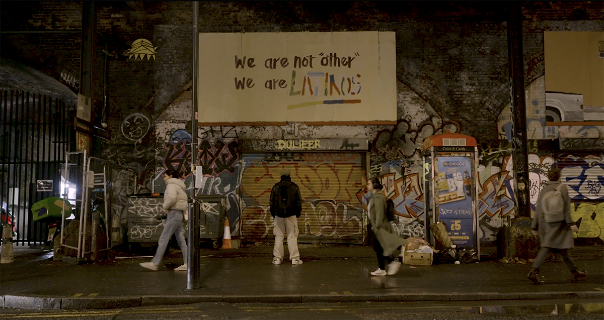 Graffiti artist looking at mural in London